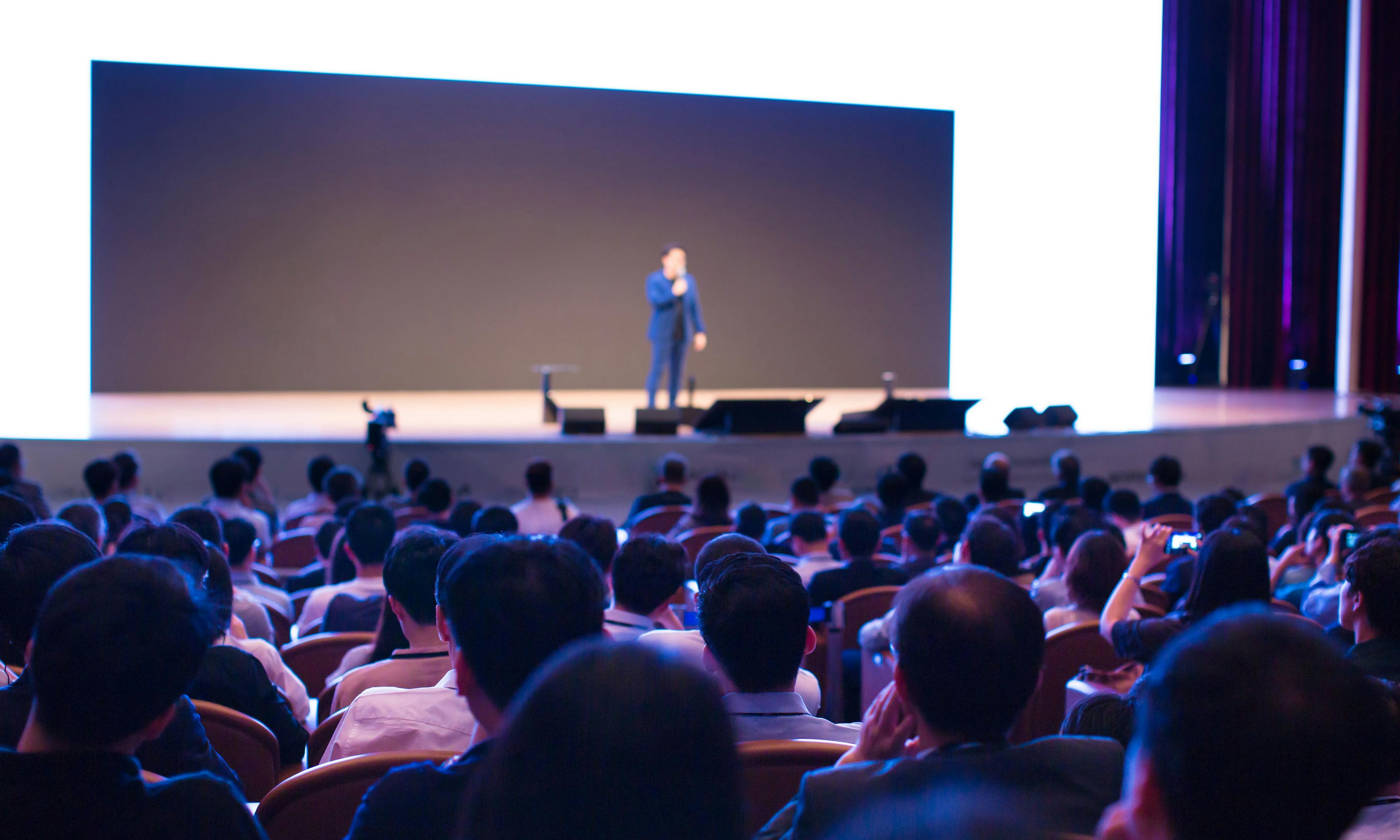 Presenter at conference giving speech