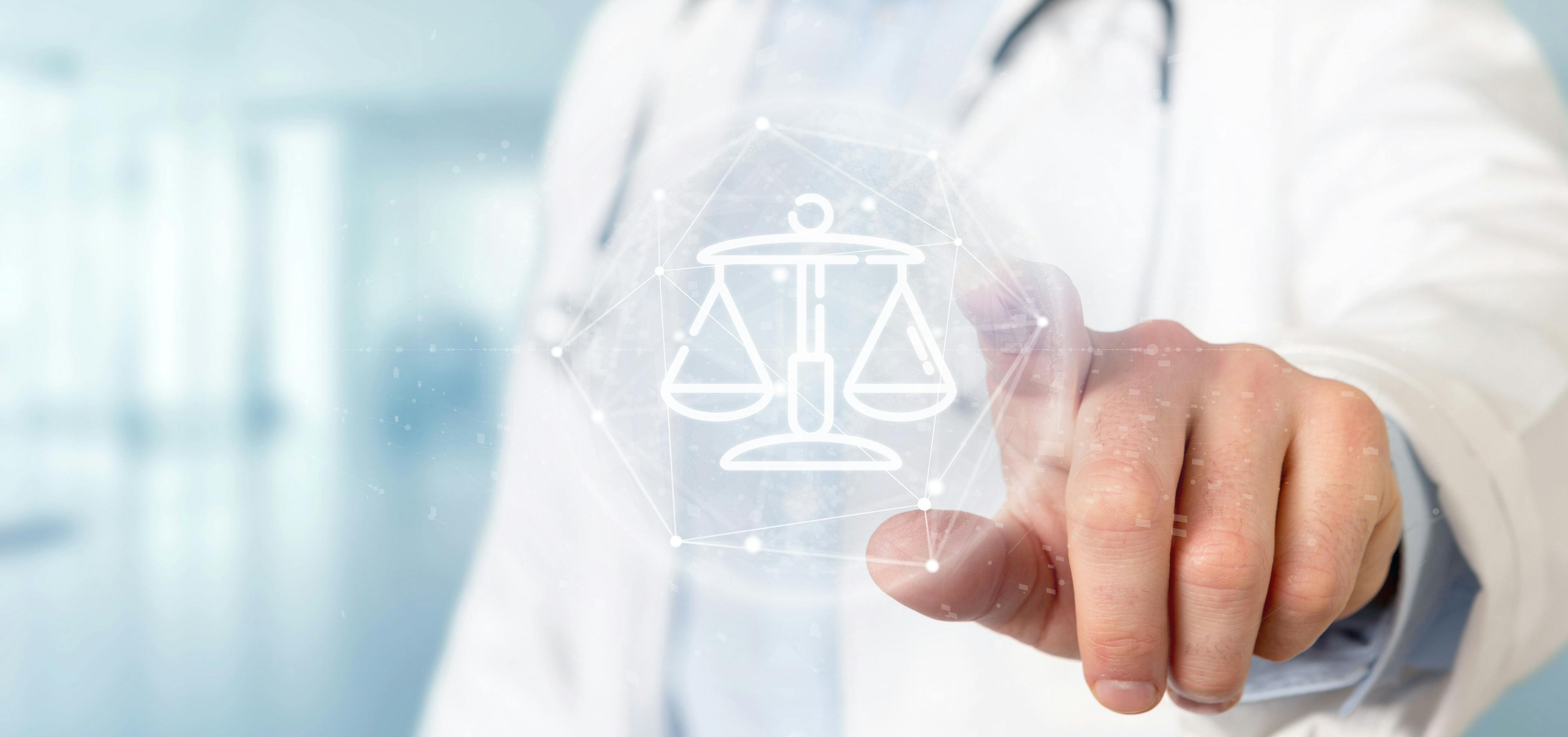 Doctor holding cloud of justice and law icon | Image Credit: © Production Perig - stock.adobe.com
