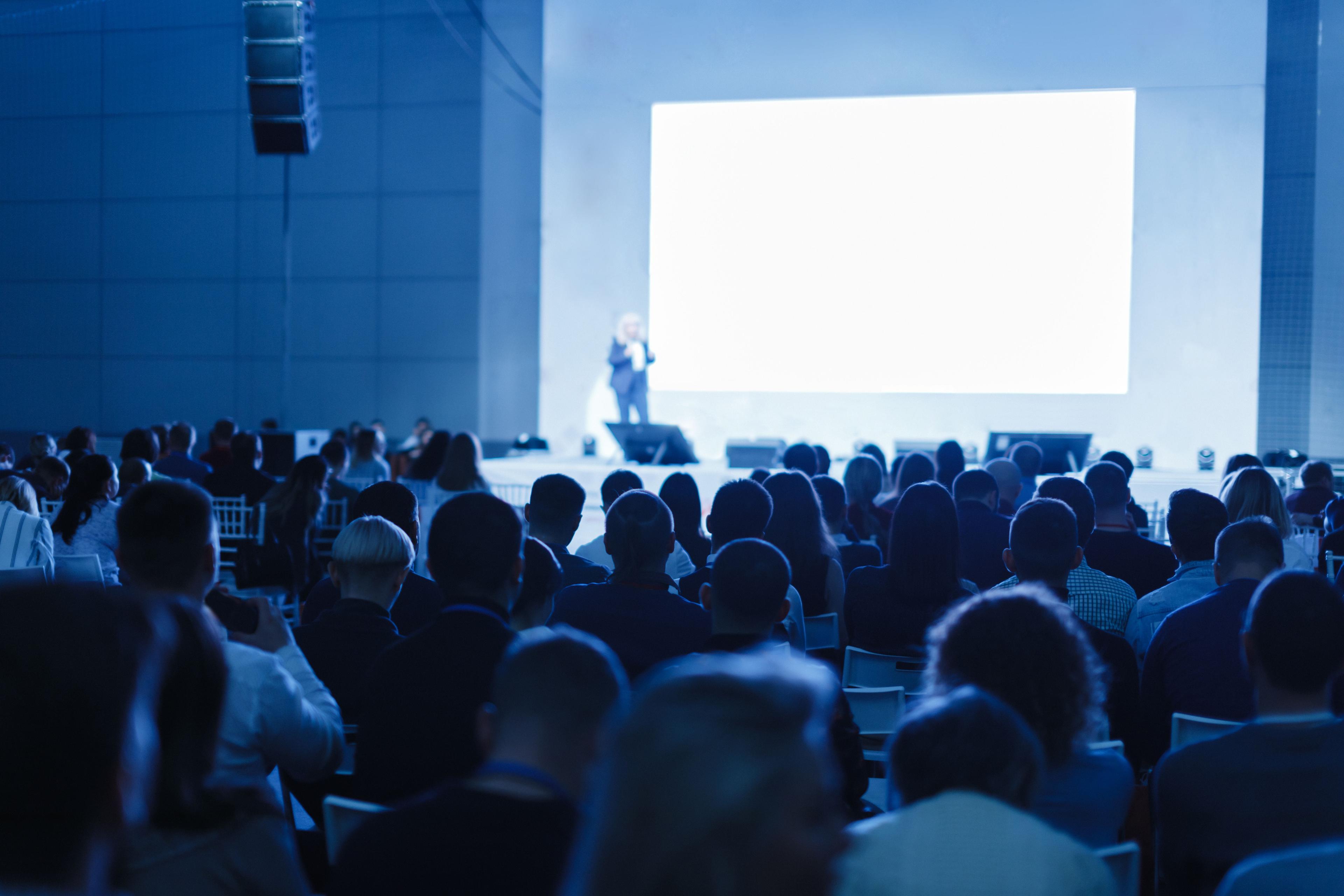 Speaker on stage giving a talk to an audience